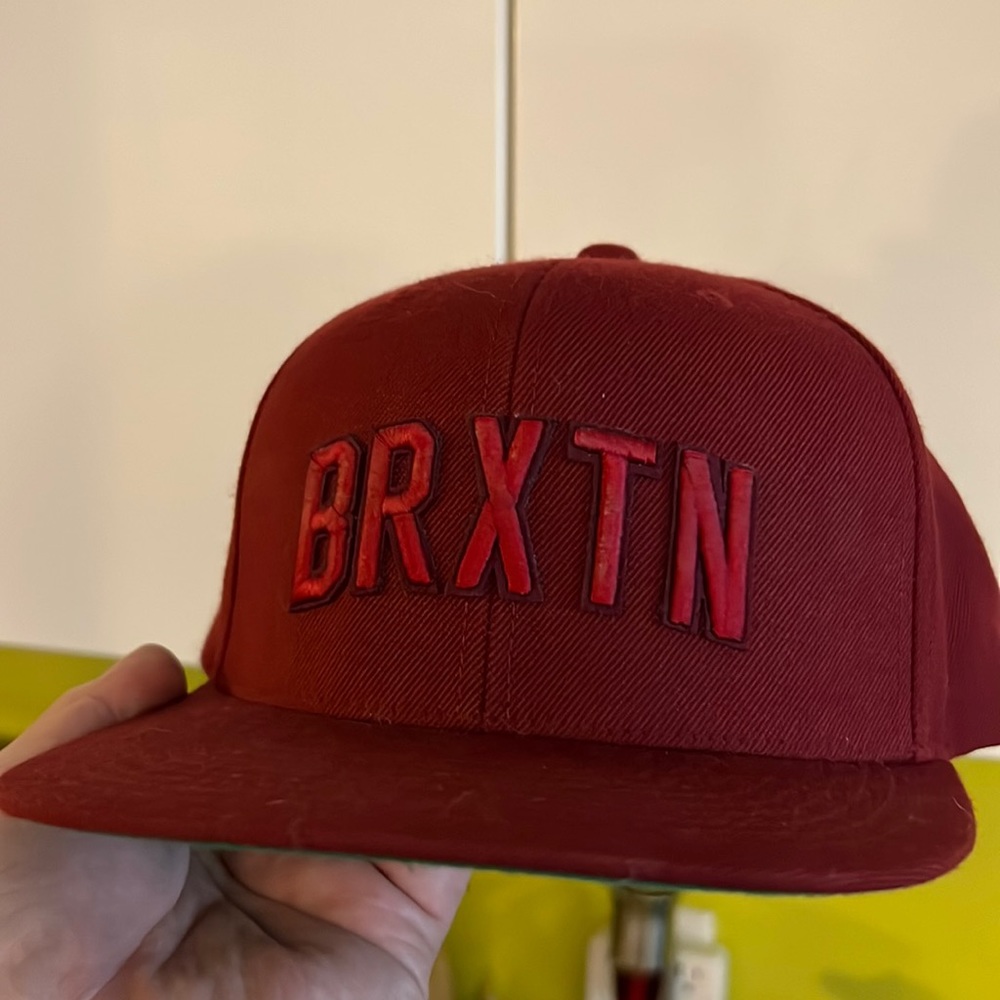 Brixton burgundy hat that’s says BRXTN